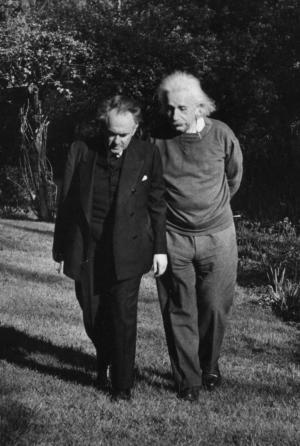 Einstein and Otto Nathan walking in garden